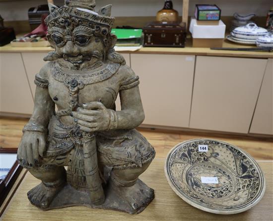 An Annamese style pottery figure of a deity and Persian fish dish